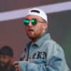 Mac Miller performs at the Splash Festival in a denim jacket