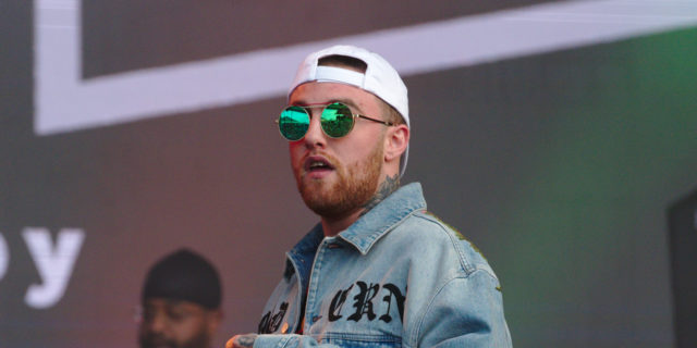 Mac Miller performs at the Splash Festival in a denim jacket