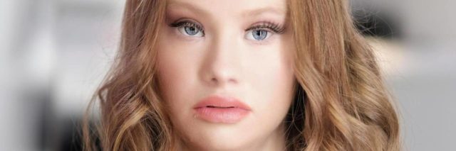 A portrait of Madeline Stuart looking at the camera