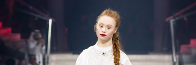 Madeline Stuart walks the runway in a black and white outfit