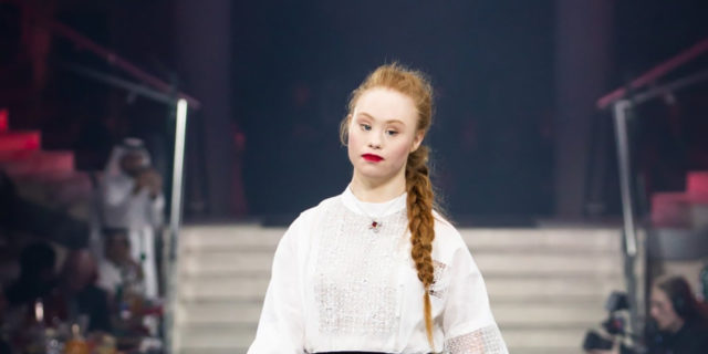 Madeline Stuart walks the runway in a black and white outfit