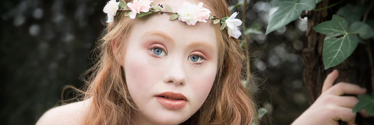 Photo Shoot With Madeline Stuart, Model With Down Syndrome Madeline Stuart poses in a white dress while holding flowers