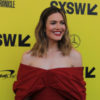 Mandy Moore poses on the red carpet in a red dress