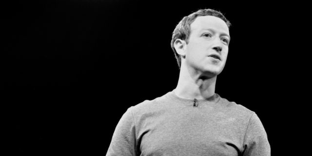 A black and white photo of Mark Zuckerberg speaking onstage