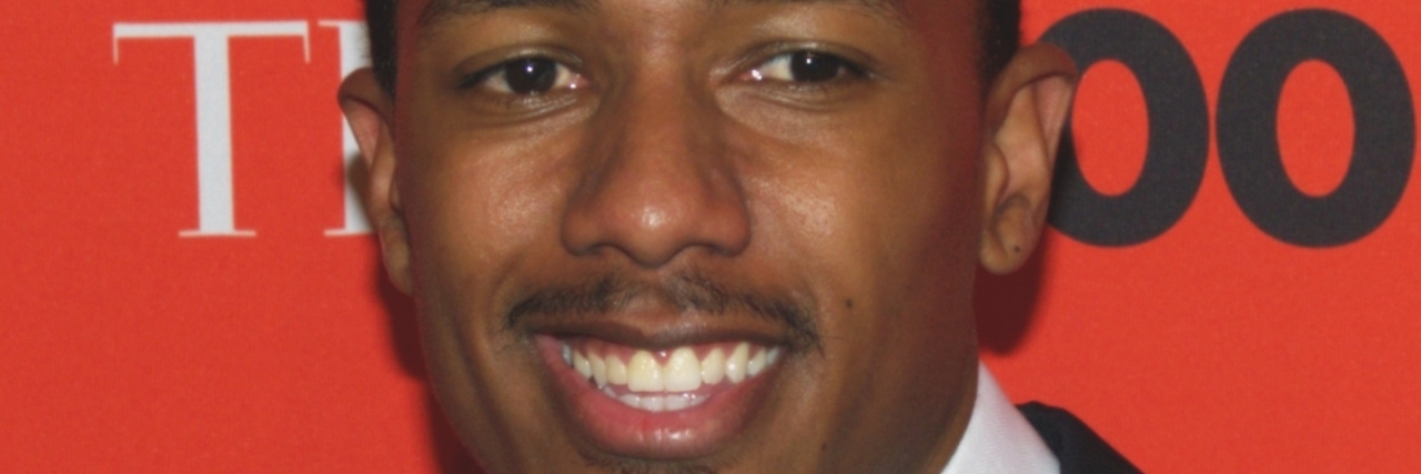 Nick Cannon smiles while posing for the red carpet