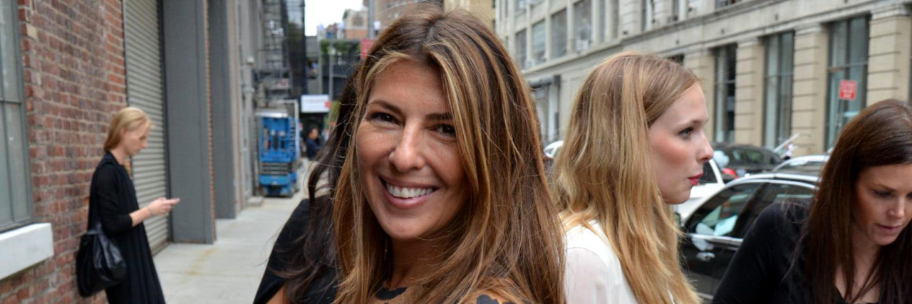 Nina Garcia smiles for the camera before going into a building