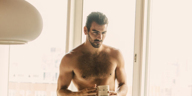 A shirtless Nyle DiMarco poses in white pants