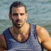 Nyle DiMarco models for the camera in the ocean at a beach