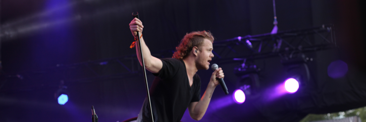 Dan Reynolds Achieving Remission With Lifestyle Changes: What to Know Dan Reynolds sings onstage while wearing a black outfit
