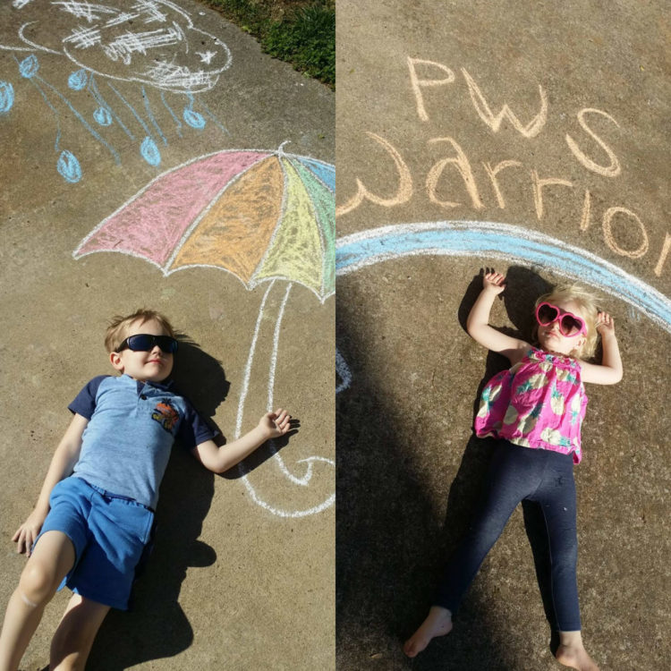 little kids in front of chalk drawings. Little boy in front of drawn chalk umbrella