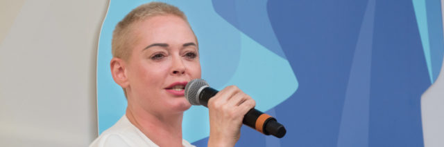 Rose McGowan speaking at an event.