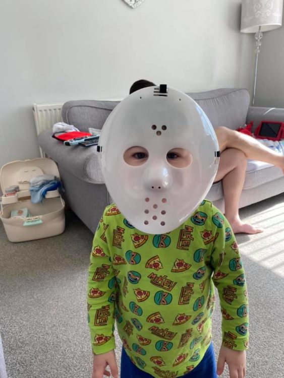 Little boy wearing hockey mask