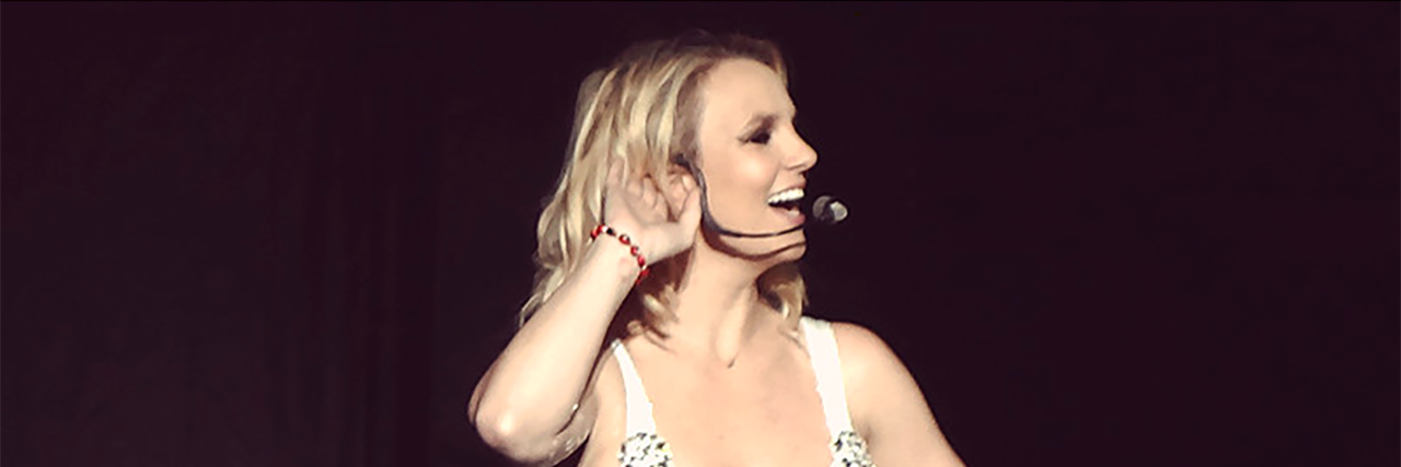 Britney Spears smiles onstage at one of her concerts