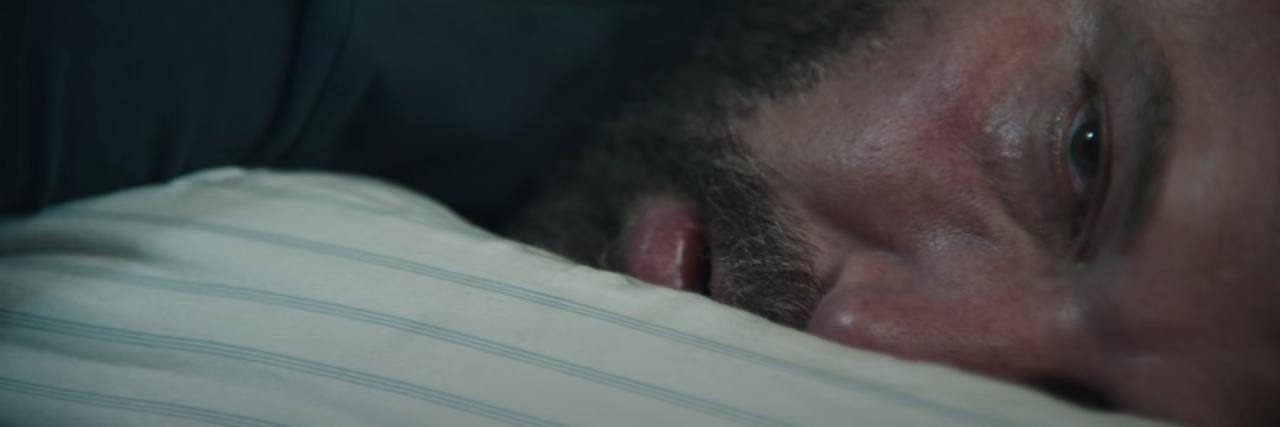 Is Ben Affleck's Addiction Portrayal in 'The Way Back' Accurate? screenshot still of Ben Affleck in addiction and sports movie The Way Back, showing the actor face-down on a bed with his eyes open