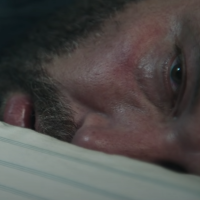 screenshot still of Ben Affleck in addiction and sports movie The Way Back, showing the actor face-down on a bed with his eyes open