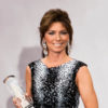Shania Twain holds a Juno while wearing a black and white outfit