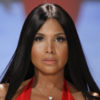 Toni Braxton walks the runway while wearing a red dress