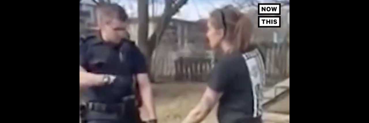 police officer holding woman's service dog