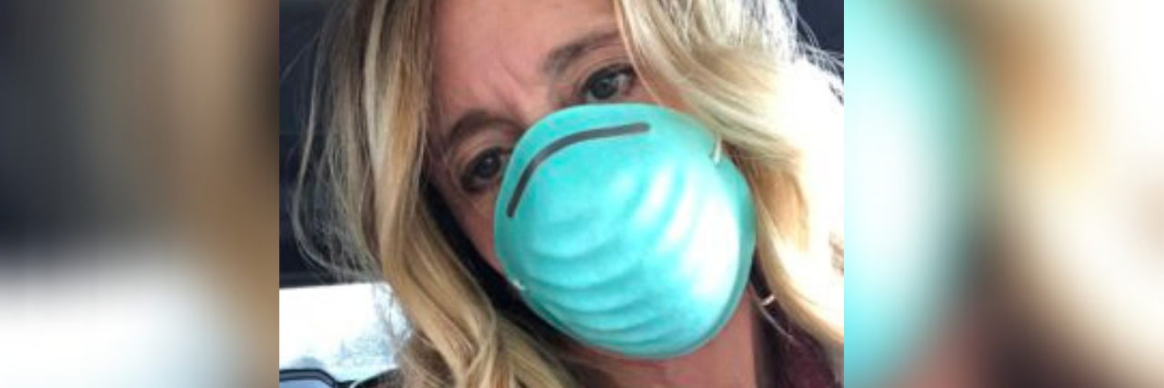Women Need to Be Able to Talk Openly About Menopause and Mental Health selfie of author wearing blue N-95 mask
