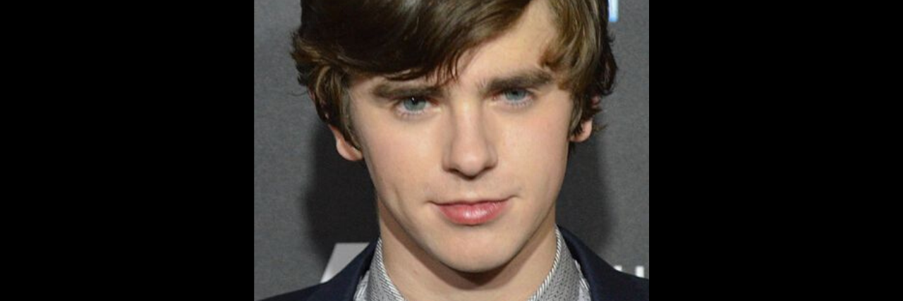'The Good Doctor' Actor Speaks Up About a Common Autism Myth During Interview Freddie Highmore stands on the red carpet in a suit