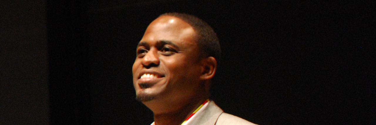 Wayne Brady Sets Out to End Stigma Surrounding Men and Mental Illness Wayne Brady smiles onstage in a tan suit
