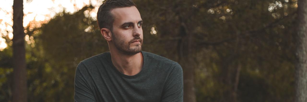 What Life Is Like With Facioscapulohumeral Muscular Dystrophy photo of man with serious expression sitting on bench