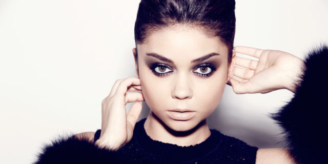 Sarah Hyland poses while wearing a black ensemble