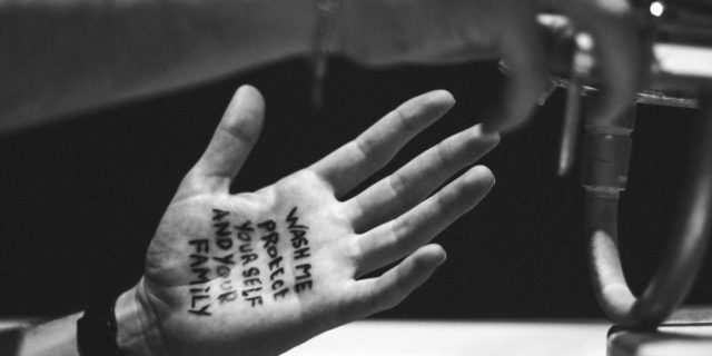 To the Psychiatrist Who Said It ‘Wouldn’t Be so Bad’ to Have OCD During the COVID-19 Pandemic black and white photo of person washing hands with the words "wash me protect yourself and your family" written on one in pen