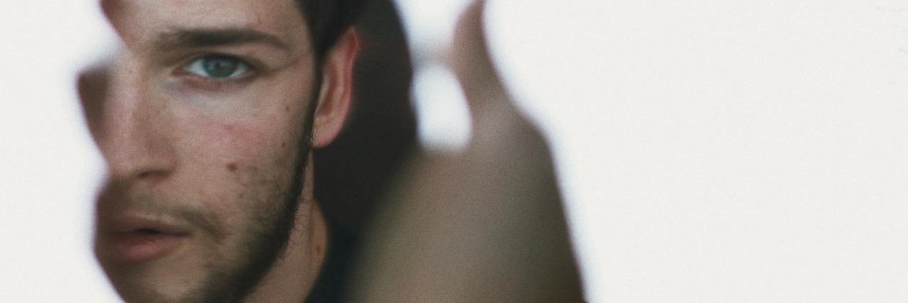 5 Tips for Healing From Abusive or Neglectful Parents A man looking at himself in the mirror