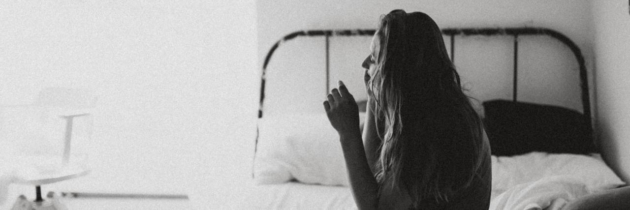 What to Remember When You're Struggling With the Coronavirus Pandemic black and white photo of woman sitting on bed while talking on phone