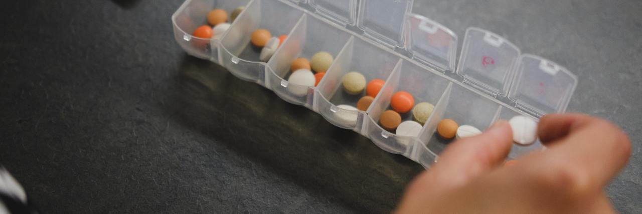 Don't Let Anyone 'Pill Shame' You If You Need Anxiety Meds COVID-19 person taking medication