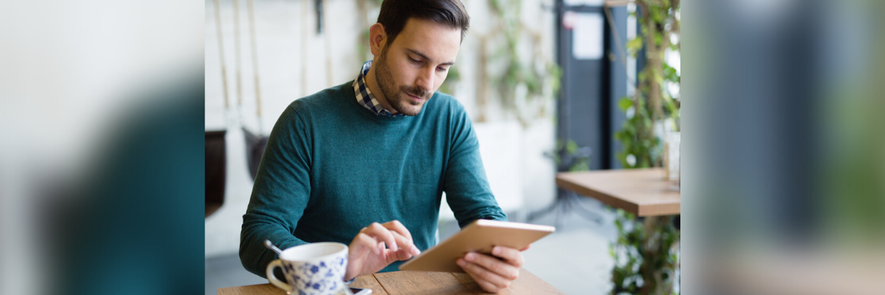 Dealing with Cyberbullying While Living With Epilepsy Man using tablet