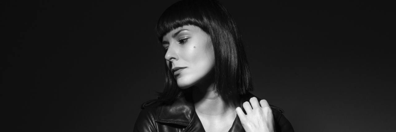 With All I've Overcome Cancer Shouldn't Define My Worth In COVID-19 black and white photo of a woman in a leather jacket looking away