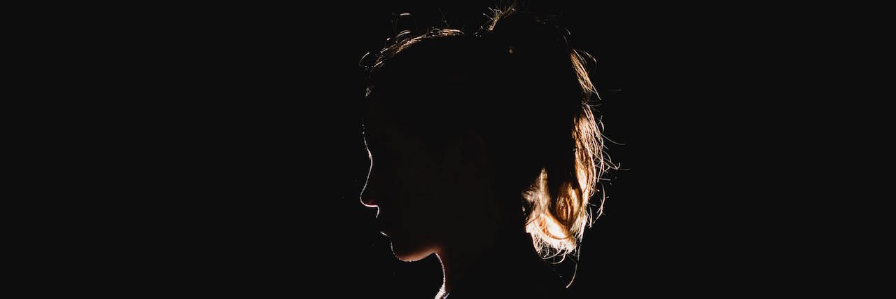 Profile of woman in the dark