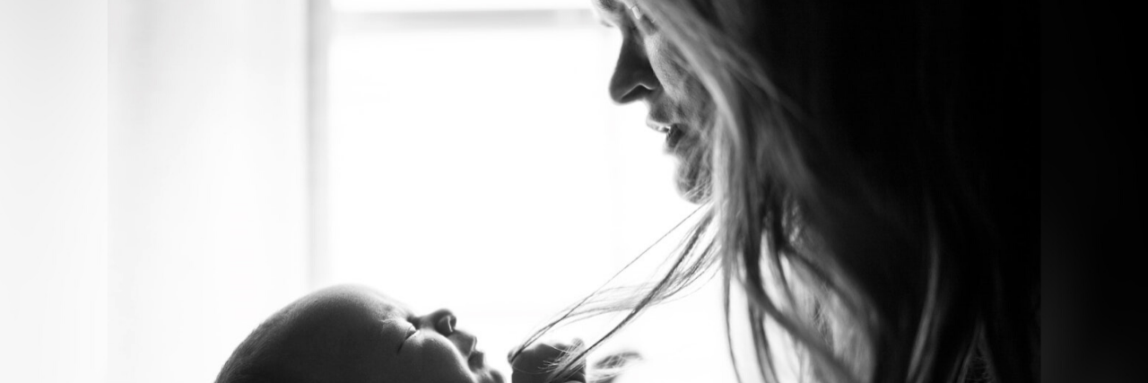 Reaching Out for Help and Finding Sobriety as a New Mother Black and white photo of mother holding a baby