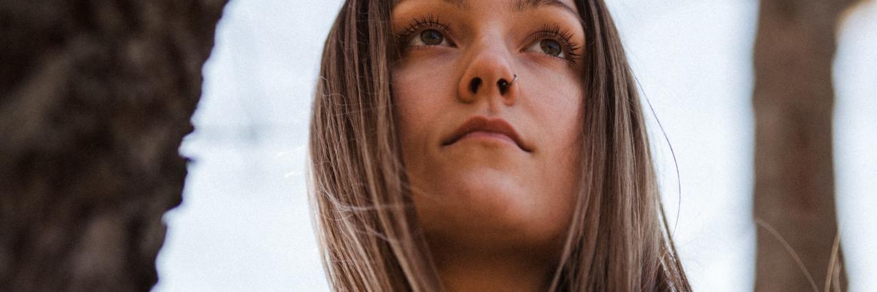 Body Dysmorphia and Eating Disorder Triggers During COVID-19 photo of woman in tree looking into distance