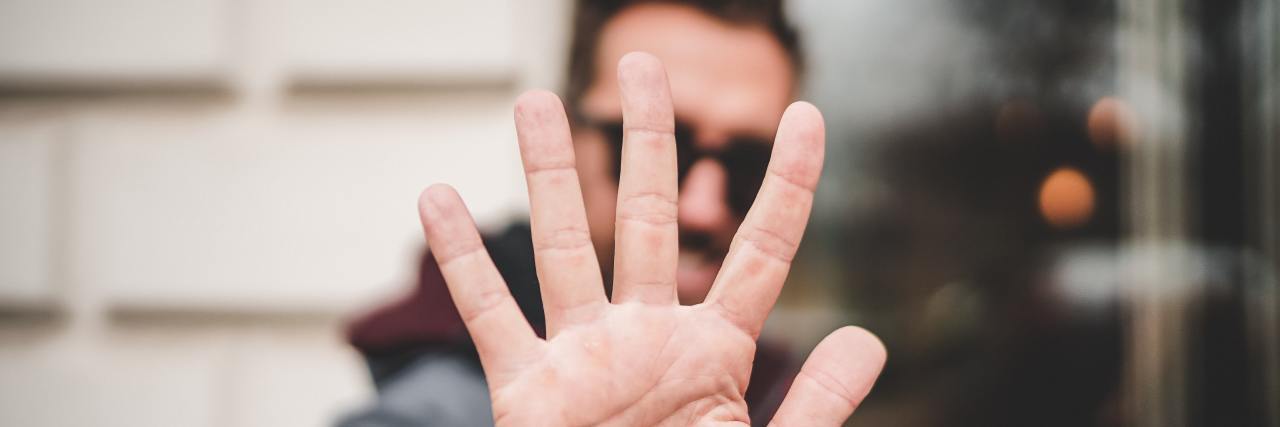 What to Know About Depression When You Don't Know Where to Start photo of man holding up hand to camera