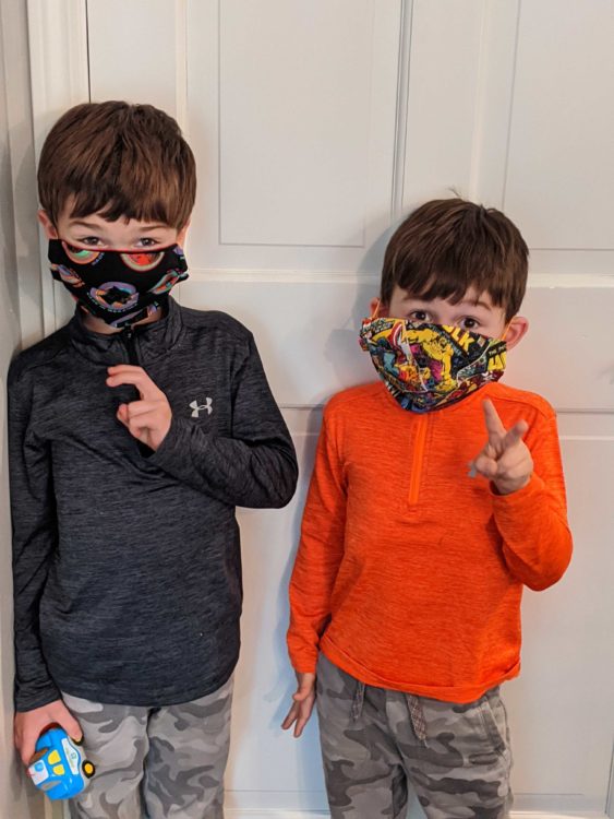 two kids wearing superhero face masks