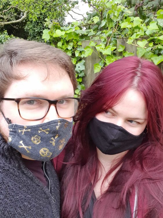 couple wearing black face masks