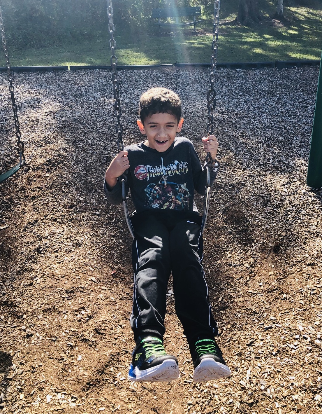 Nicole's son on a swing.