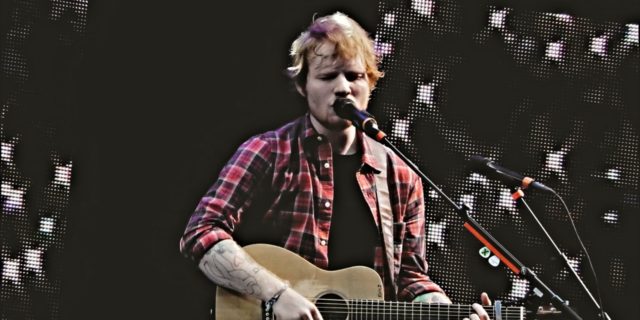 Ed Sheeran performs at a festival in a plaid shirt