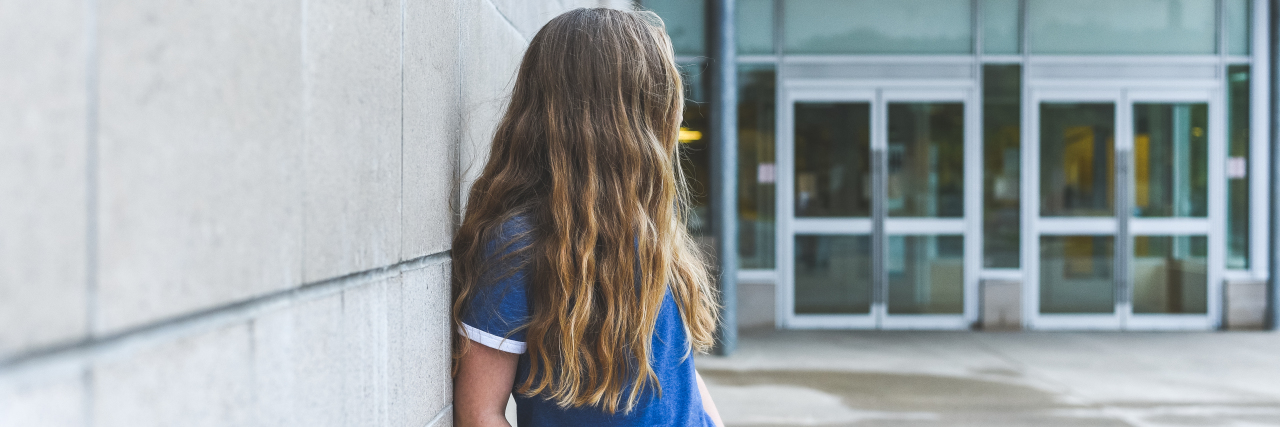 Working Through Receptive-Expressive Language Disorder as a Child a girl standing alone in the school yard