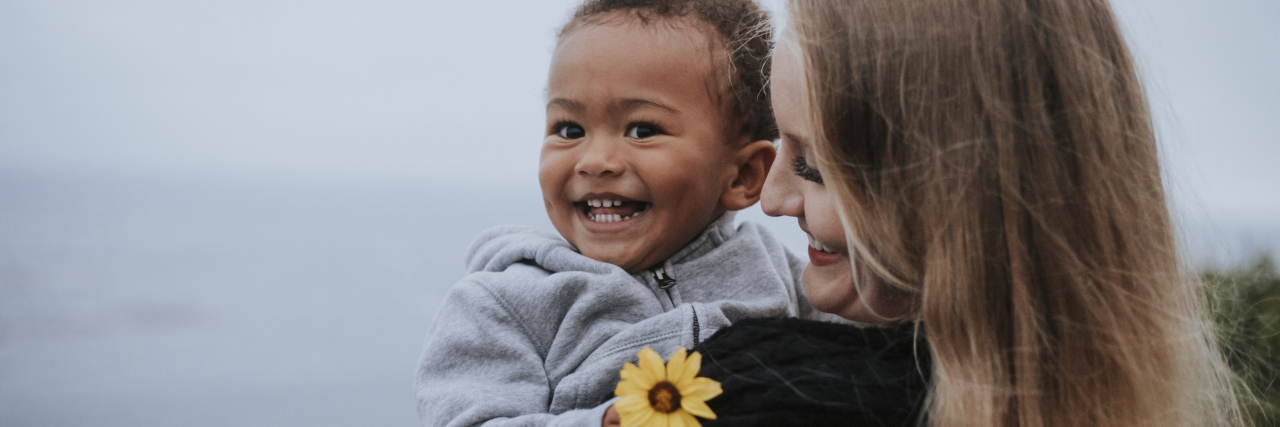 5 Things Moms Should No Longer Feel Guilty About a mom holding her infant son smiling