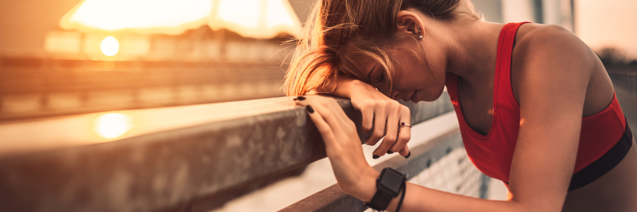 Avoiding Overexertion in Life With Complex Regional Pain Syndrome Young woman looking exhausted during her afternoon run.