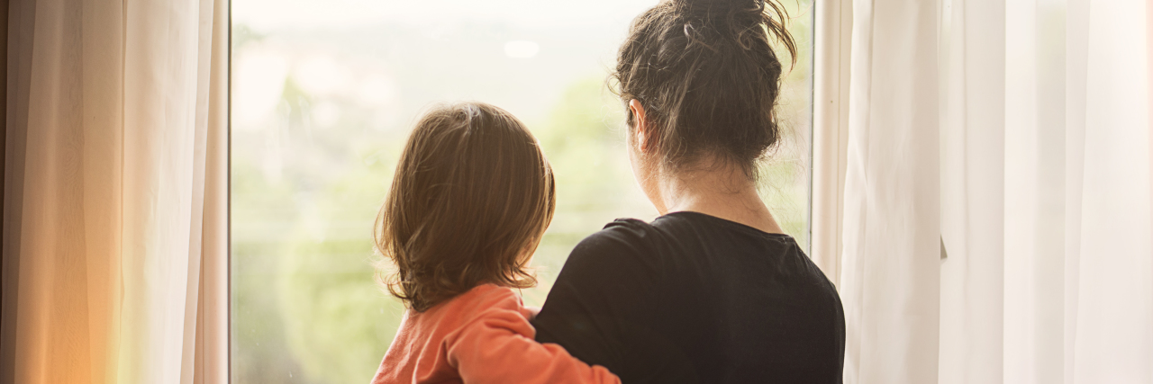 Coping With Frustration as a Parent During COVID-19 Lockdown Mother and son looking out of window.