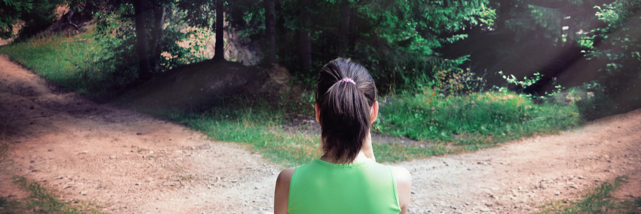The Reality of Making Tough Choices and Decisions in Your Life Young woman at a forked road