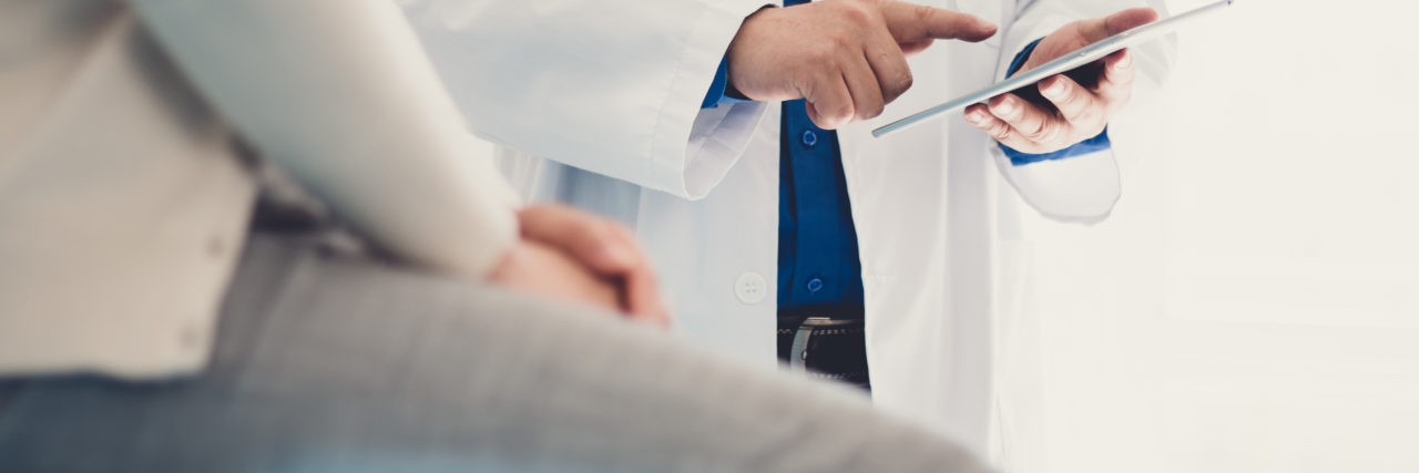 How to Know When It's Time to Change Doctors doctor and patient, patient sitting on an examining bench