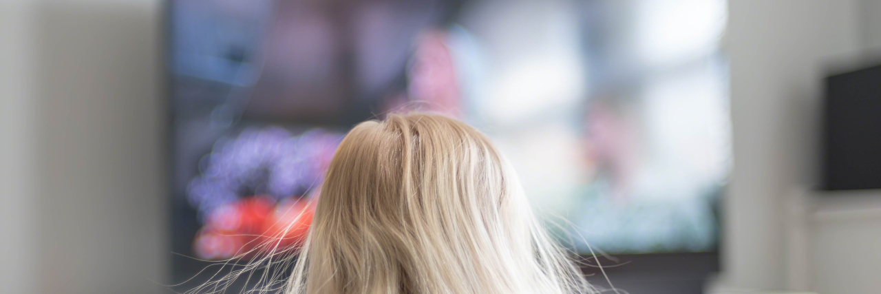 How TV Shows Are Changing Perceptions of Autism Young girl with blonde hair watching TV