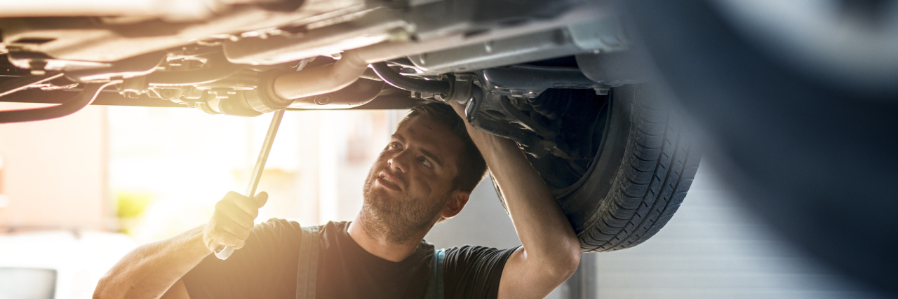 What My Mechanic Taught Me About Being Undiagnosed Car mechanic working.