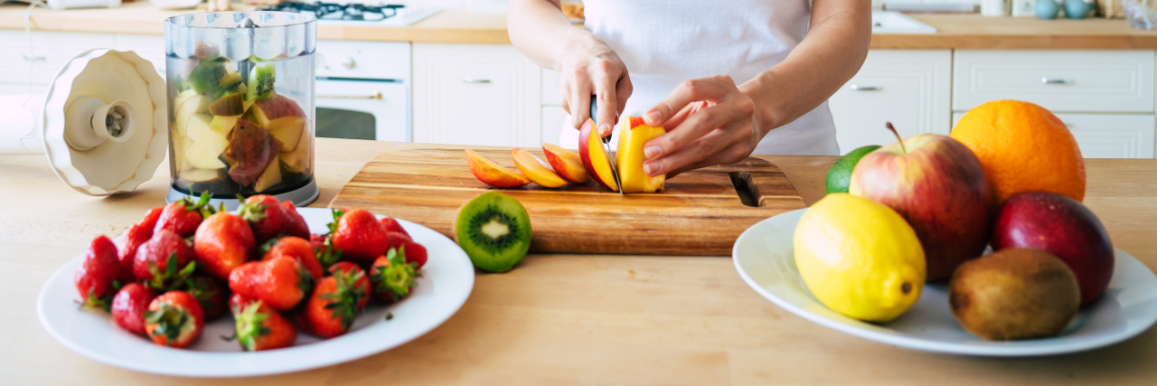 Self-Care for Parents of Kids With Disabilities During COVID-19 Woman cooking healthy food.